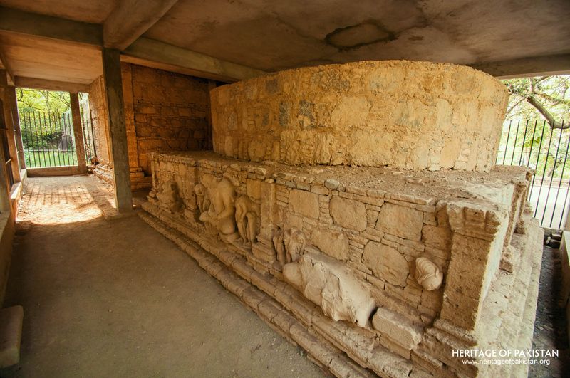 Relief carvings line the stupa base within Mohra Moradu's covered chamber.